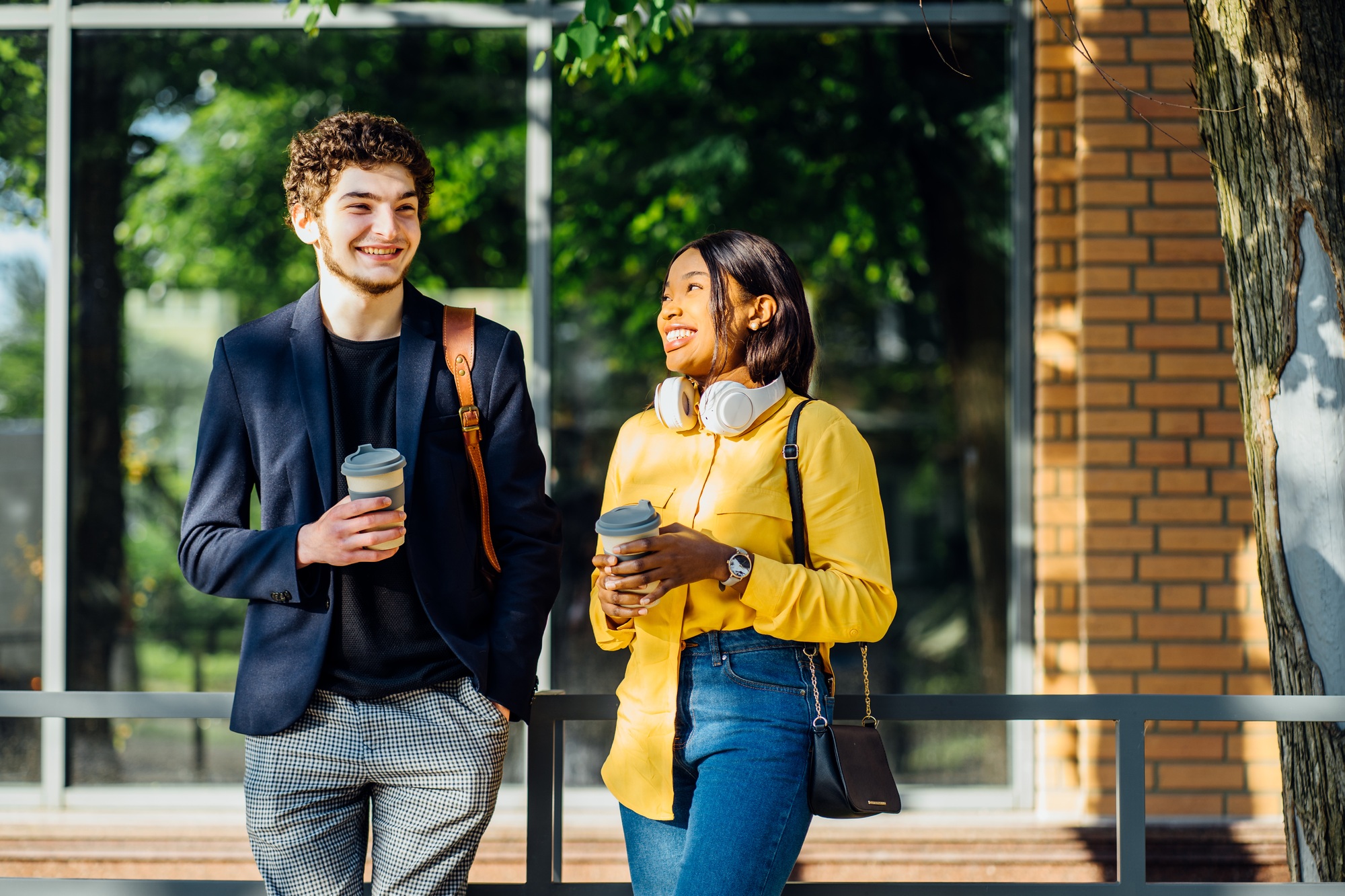 Millennial african female and french male students together outdoor at sunny summer day.
